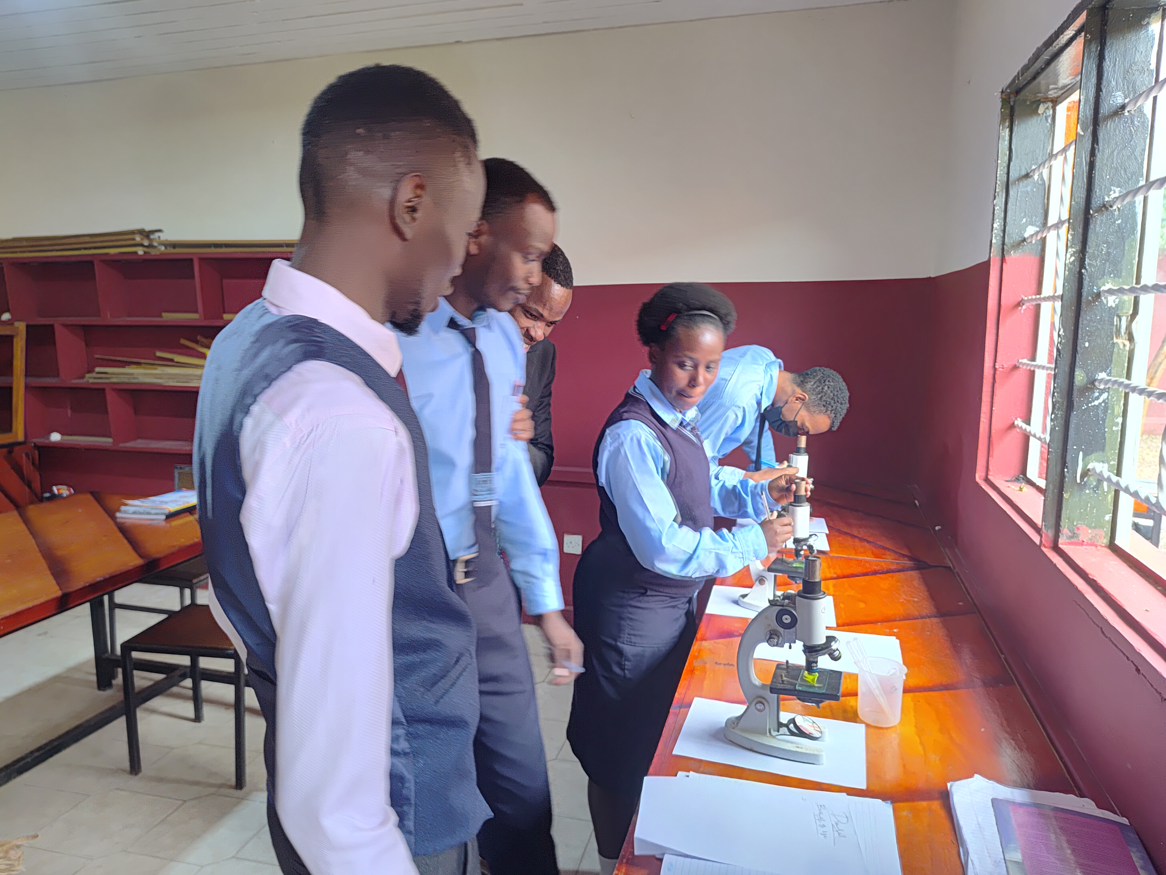 Biology student recording detailed laboratory observations.